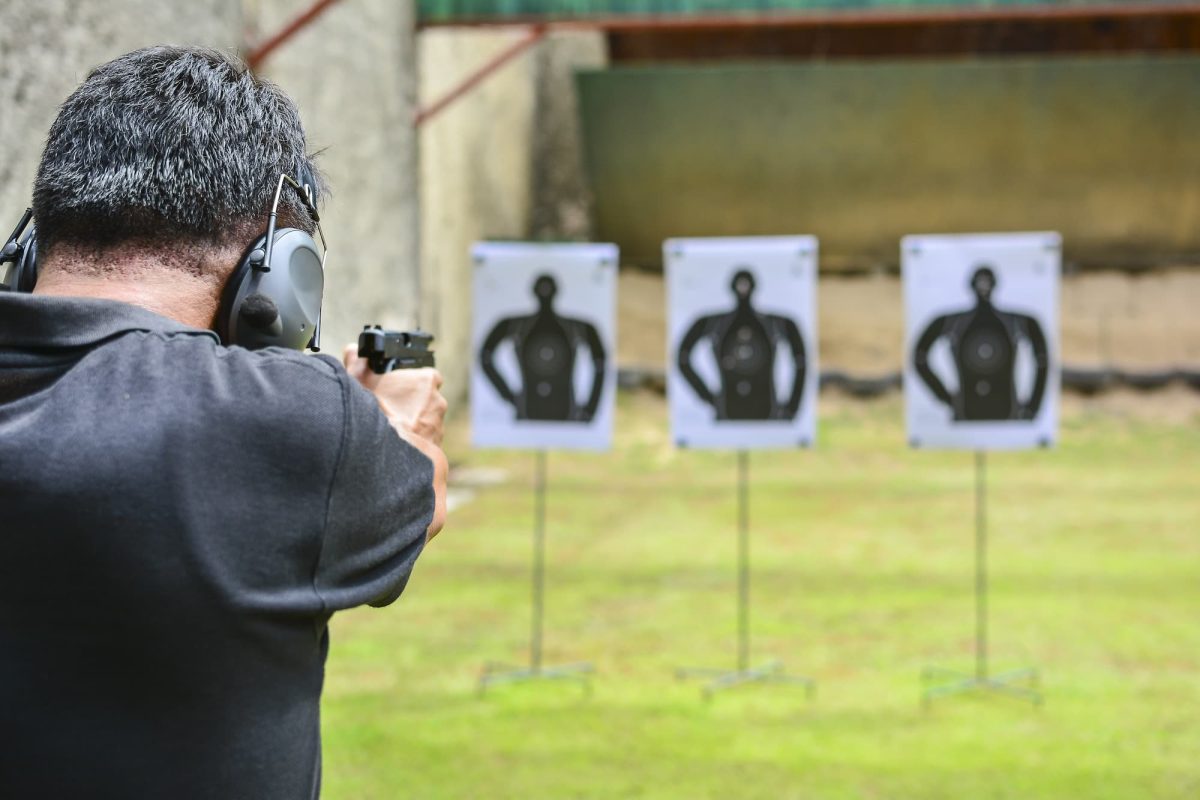 man taking aim at targets downrange